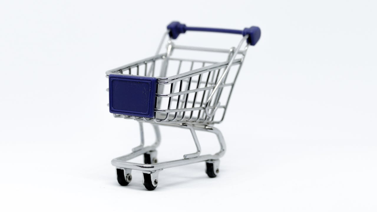 heros-img A modern miniature shopping cart on a clean white background, perfect for e-commerce concepts.
